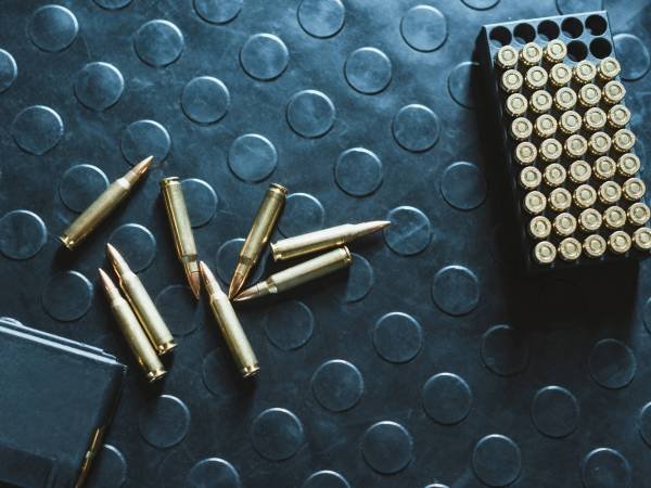 top view of rifle bullets and magazine on table
